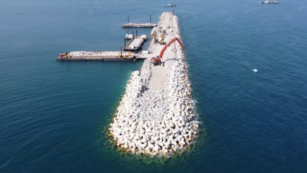 Drone aerial view of concrete armour unit installation on the offshore breakwater at Port-La-Nouvelle, France