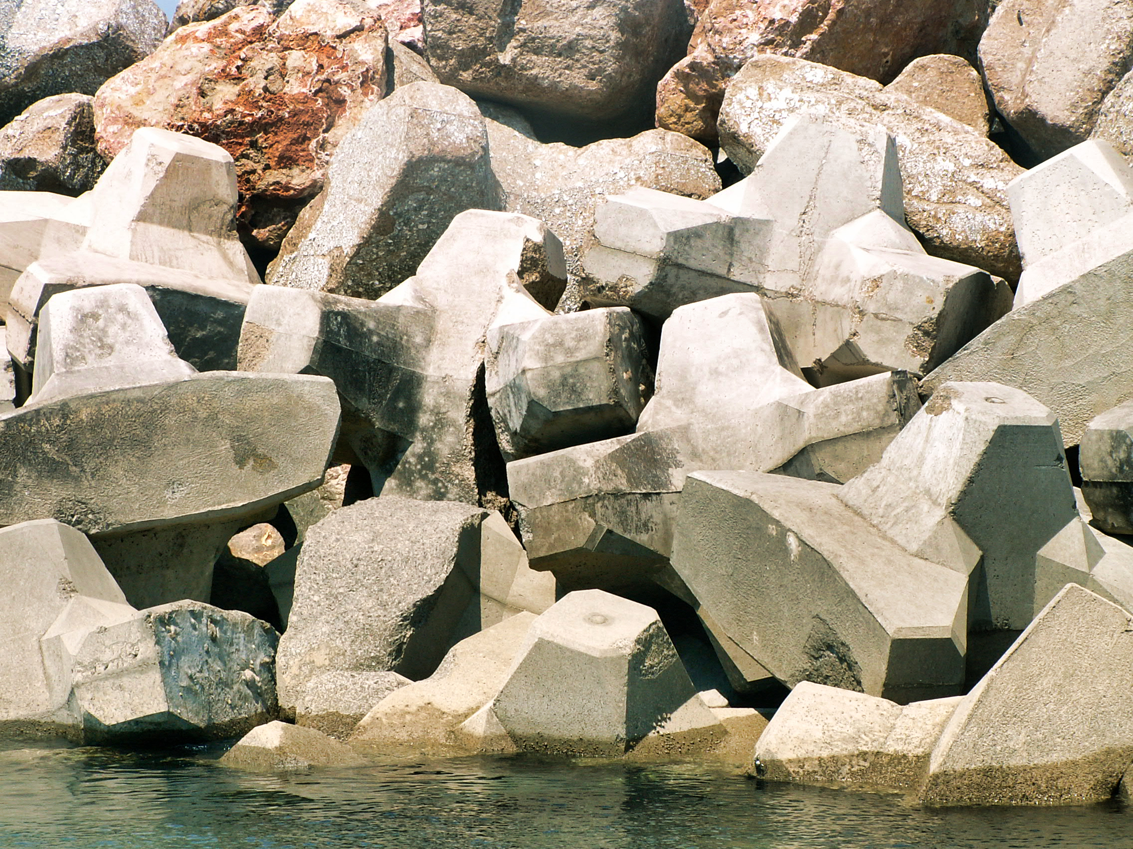 Blocs artificiels brisés à la suite du tassement de la carapace d’une digue.