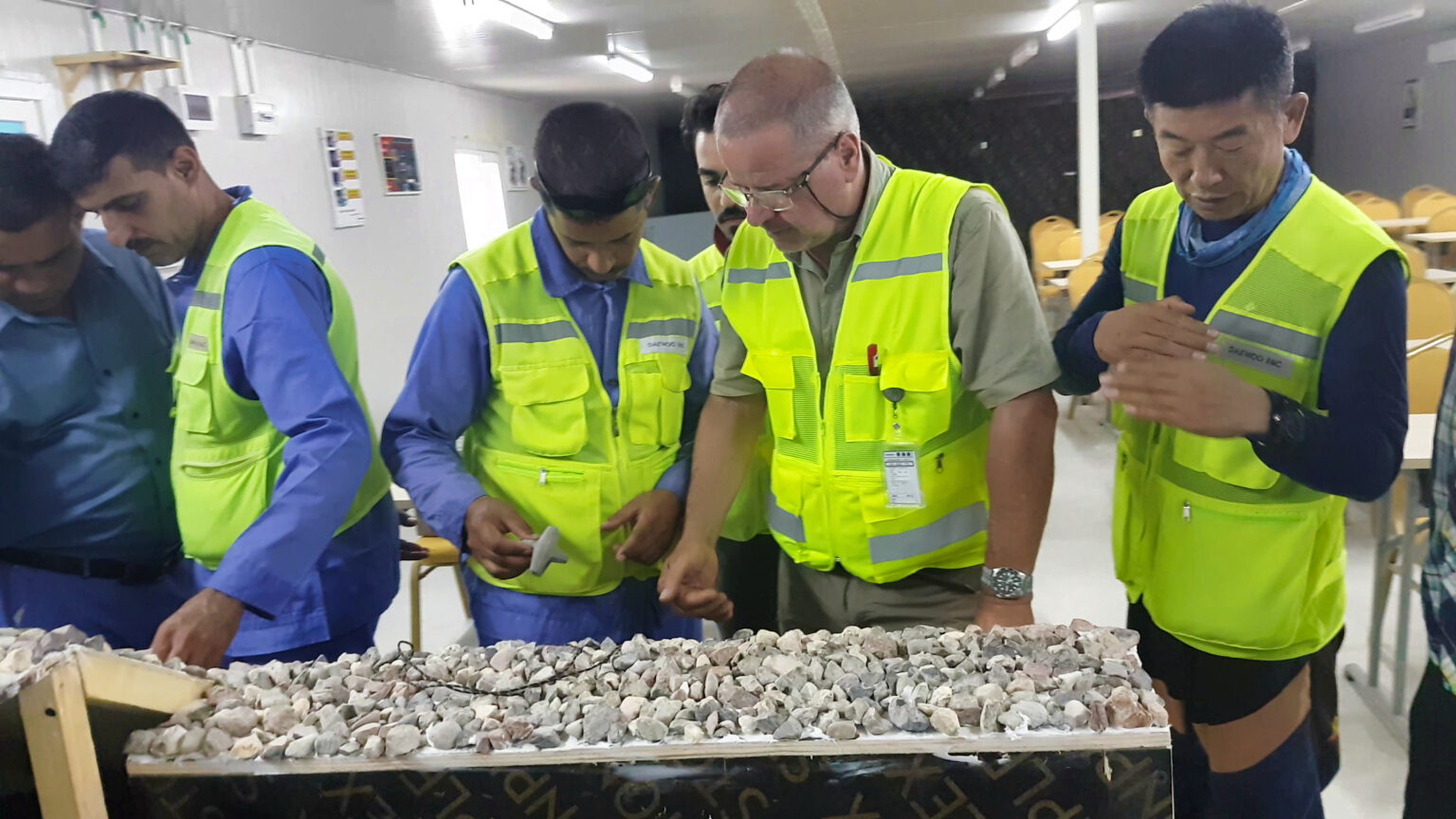 CLAS instructors conducting an indoor training session using scale models to demonstrate armour unit placement and interlocking techniques